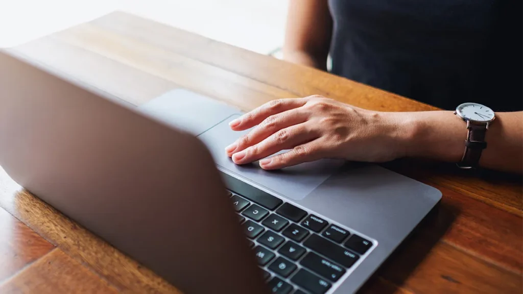 hand on laptop computer